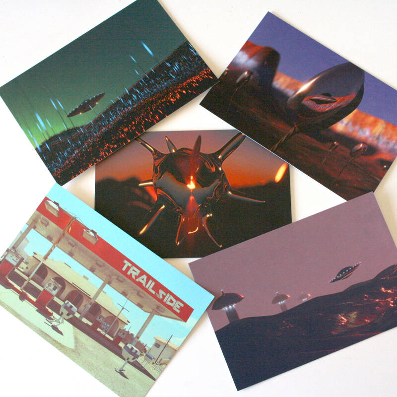 A set of 5 sci-fi images on postcards scattered on a white desk.