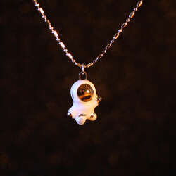 Hand sculpted tiny astronaut with 22k gold and palladium details on an 18 inch palladium plated alternating bead chain