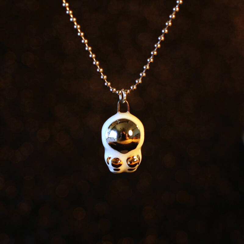 Hand sculpted astronaut with 22k gold and palladium details on a 20 inch stainless steel ball chain necklace.